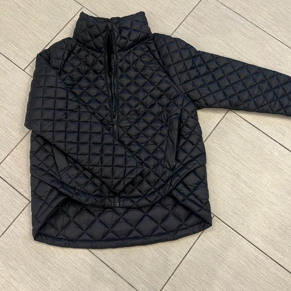Black featherless puffer jacket with hi-low length for easy movement and warmth